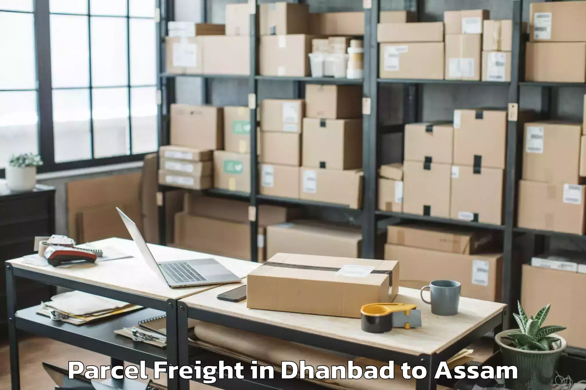 Book Dhanbad to Goshaingaon Parcel Freight Online